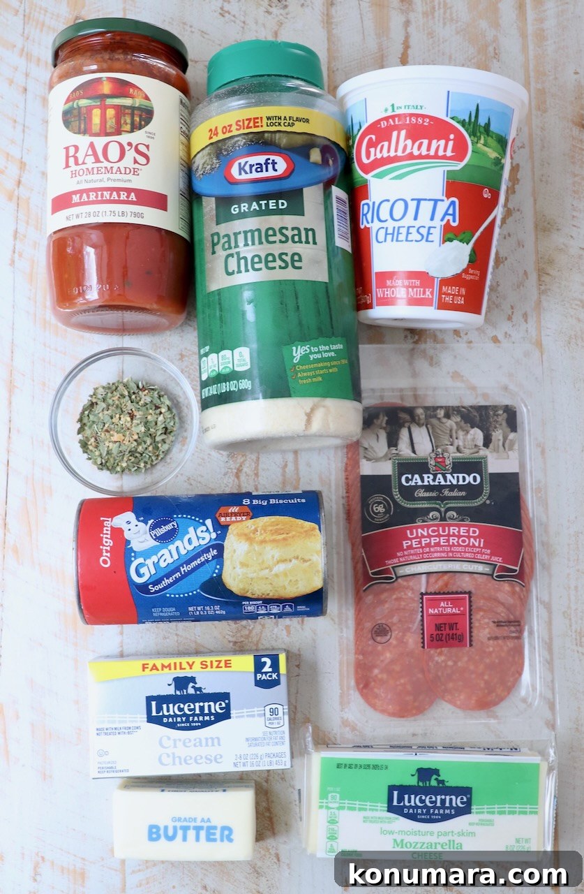 pizza dip recipe ingredients on a white wood board