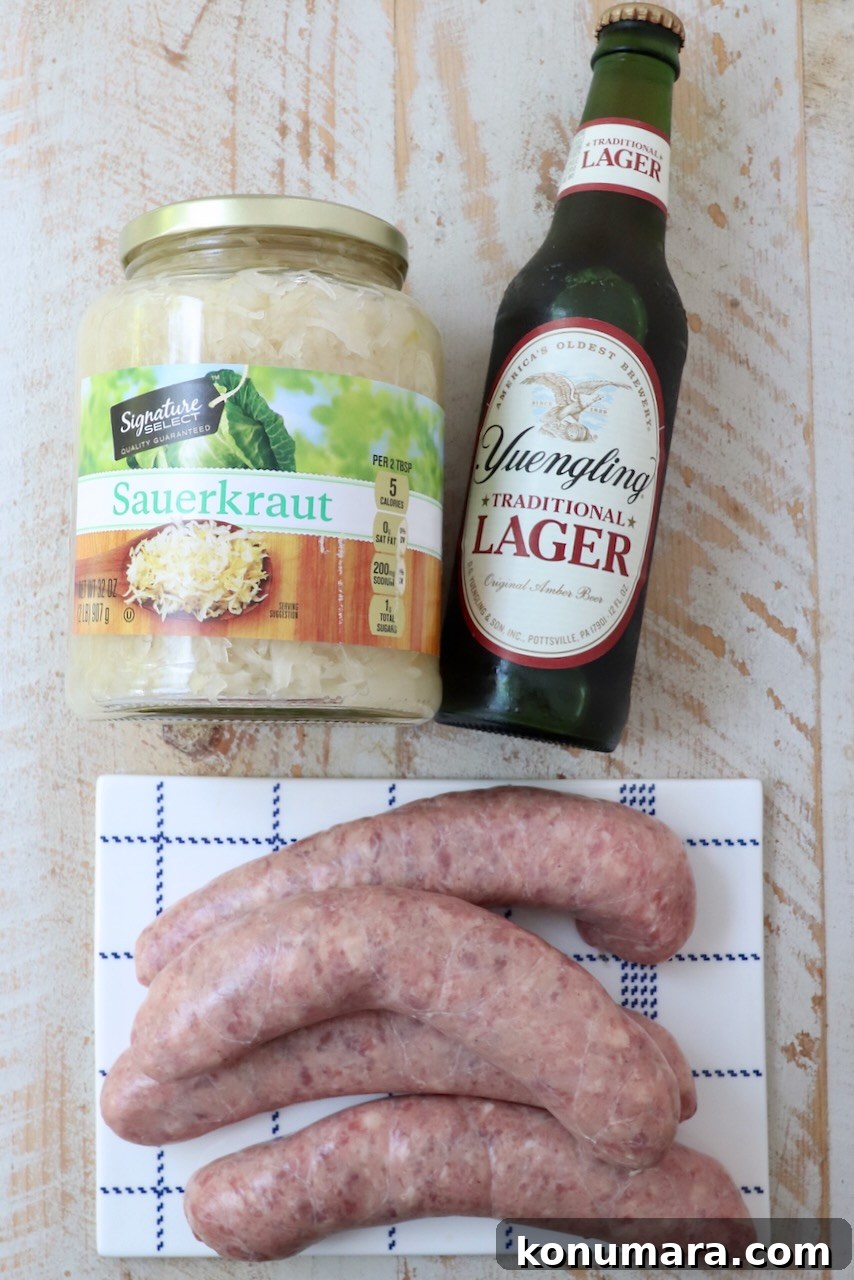 Smoky Grilled Bratwurst with Caramelized Onions 3 ingredients for beer brats on white wood board
