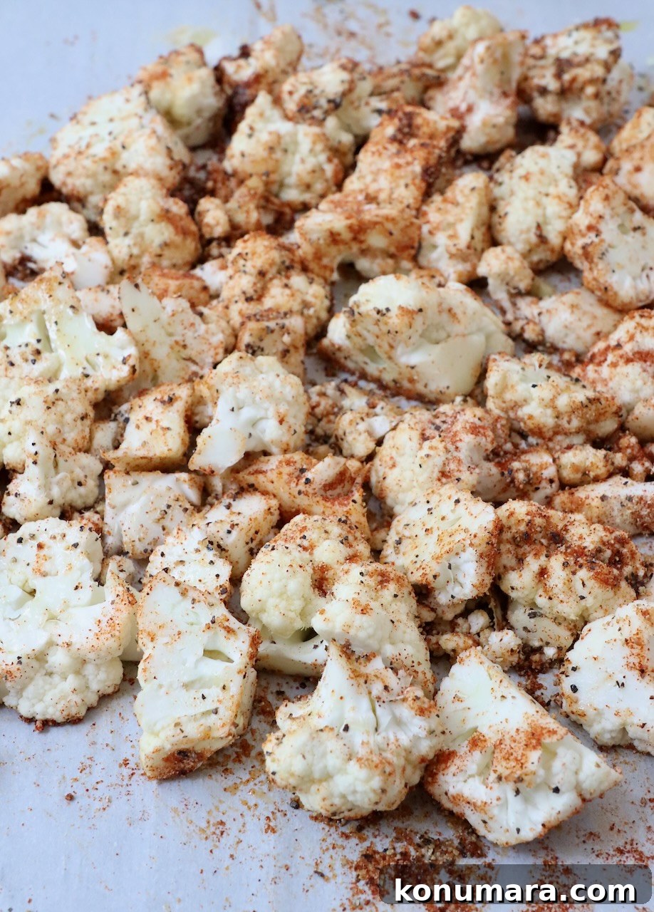 seasoned cauliflower florets on a baking sheet