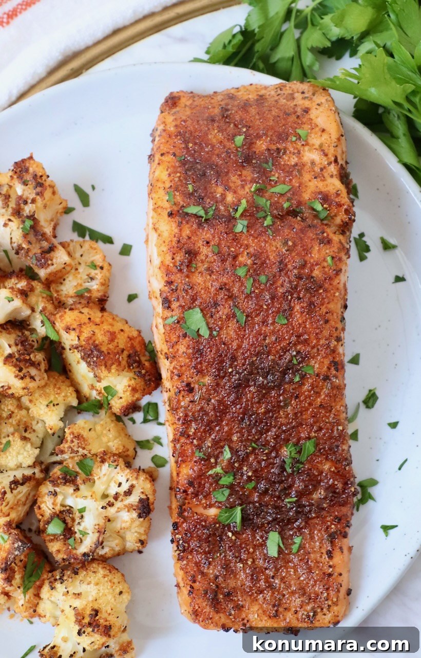 Crispy Air Fryer Salmon with Lemon Garlic Butter 6 seasoned cooked salmon on plate with roasted cauliflower