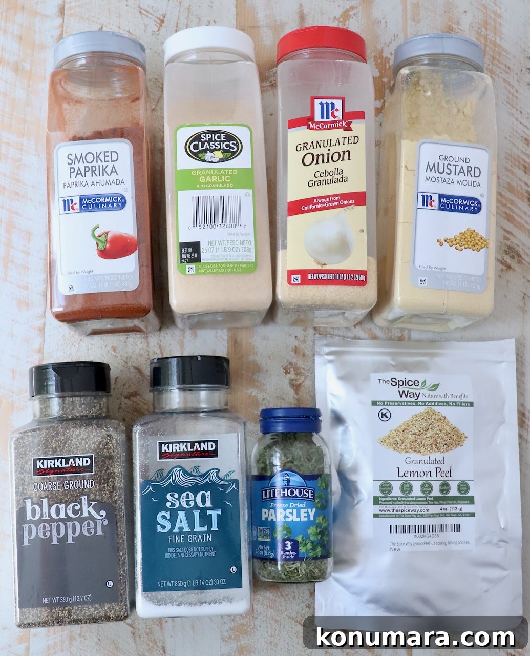 Citrus-Herb Salmon Seasoning for Grilling and Baking 3 herbs and spices in plastic containers and jars on a white wood board
