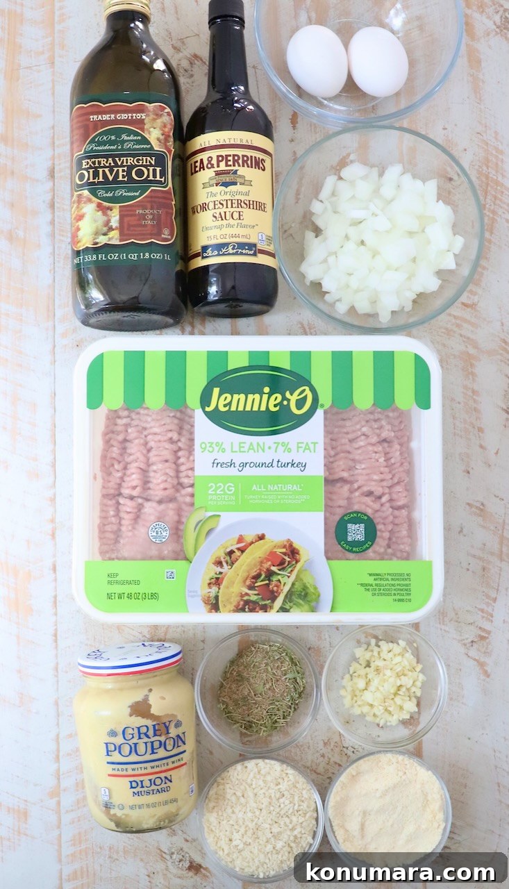 ingredients for turkey meatballs on a white wood board
