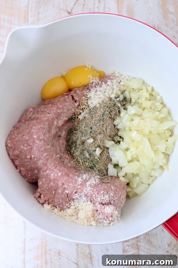 ingredients for turkey meatballs separated in a large mixing bowl