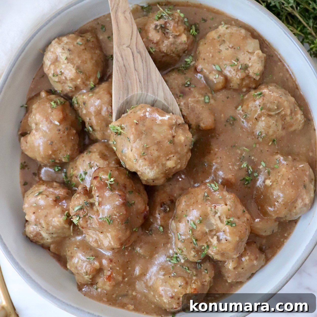 turkey meatballs in gravy in a bowl with a spoon