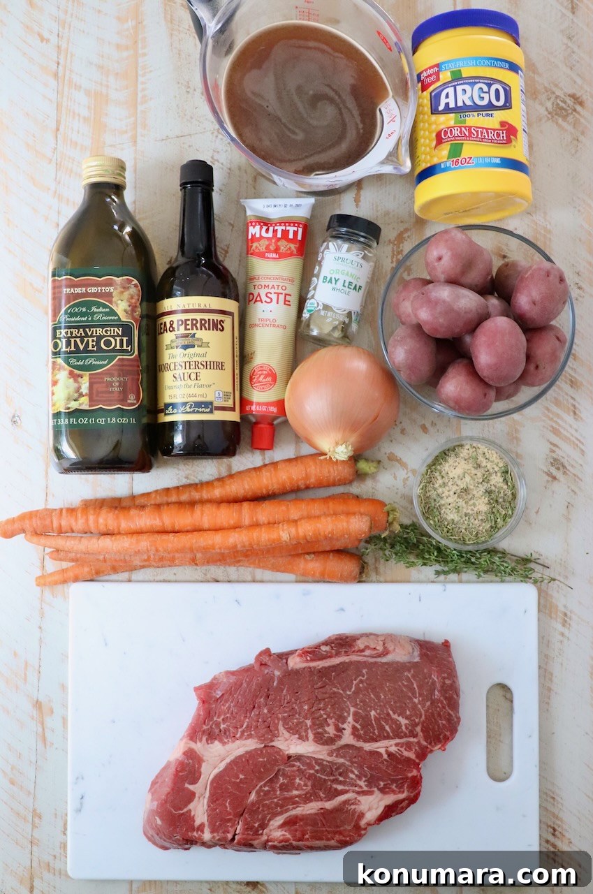 ingredients for pot roast on a white wood board