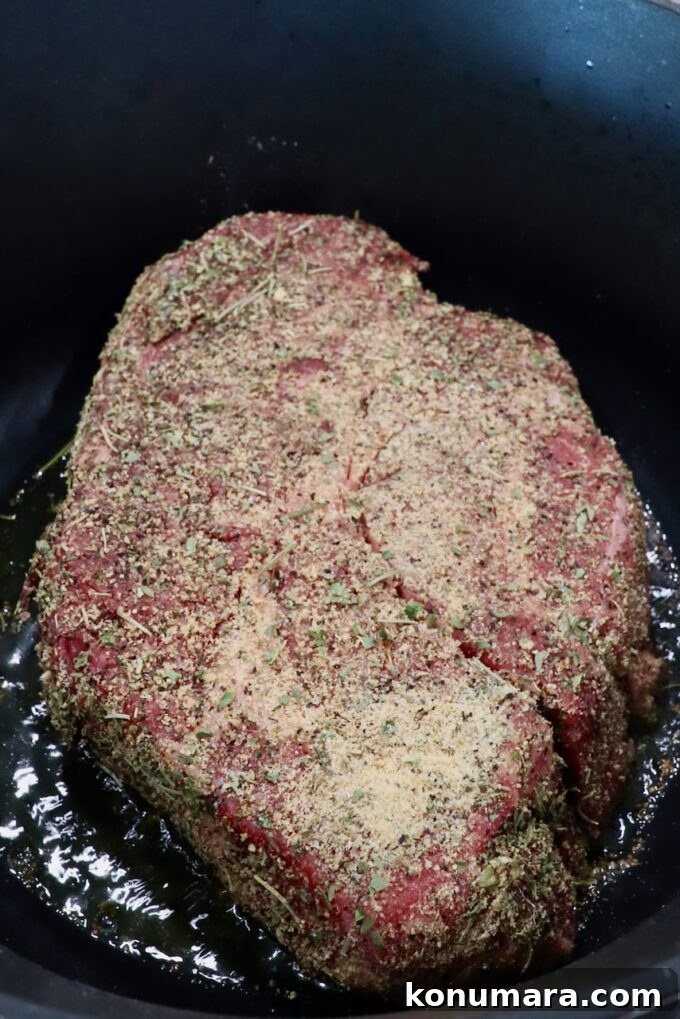 seasoned chuck roast in a large cast iron dutch oven
