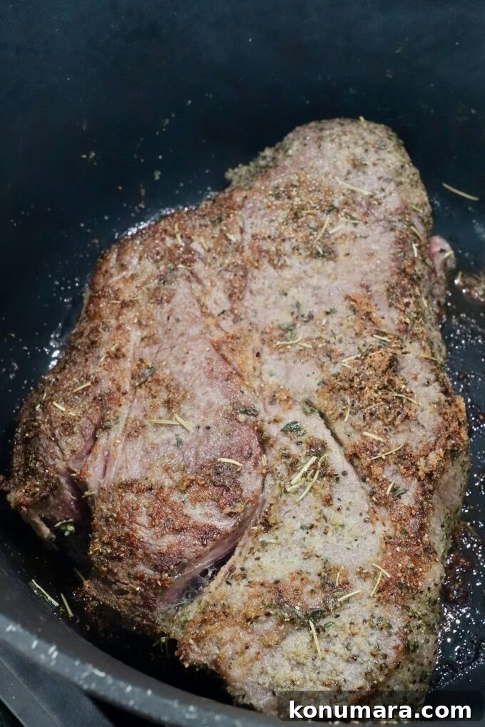 seared chuck roast in a large cast iron dutch oven