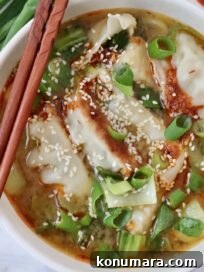 gyoza soup in bowl with chopsticks on the side