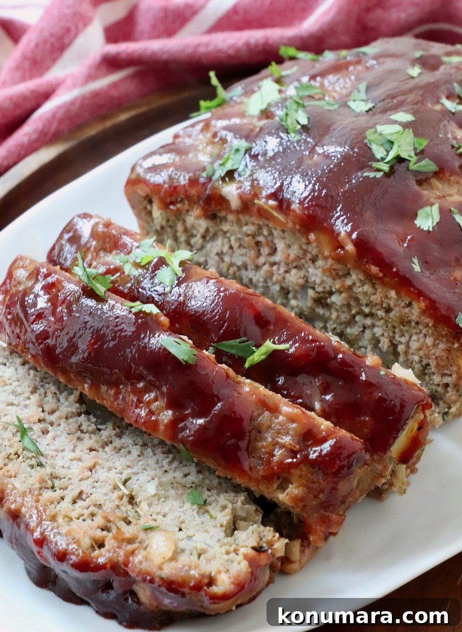 meatloaf glazed with bbq sauce sliced on a plate