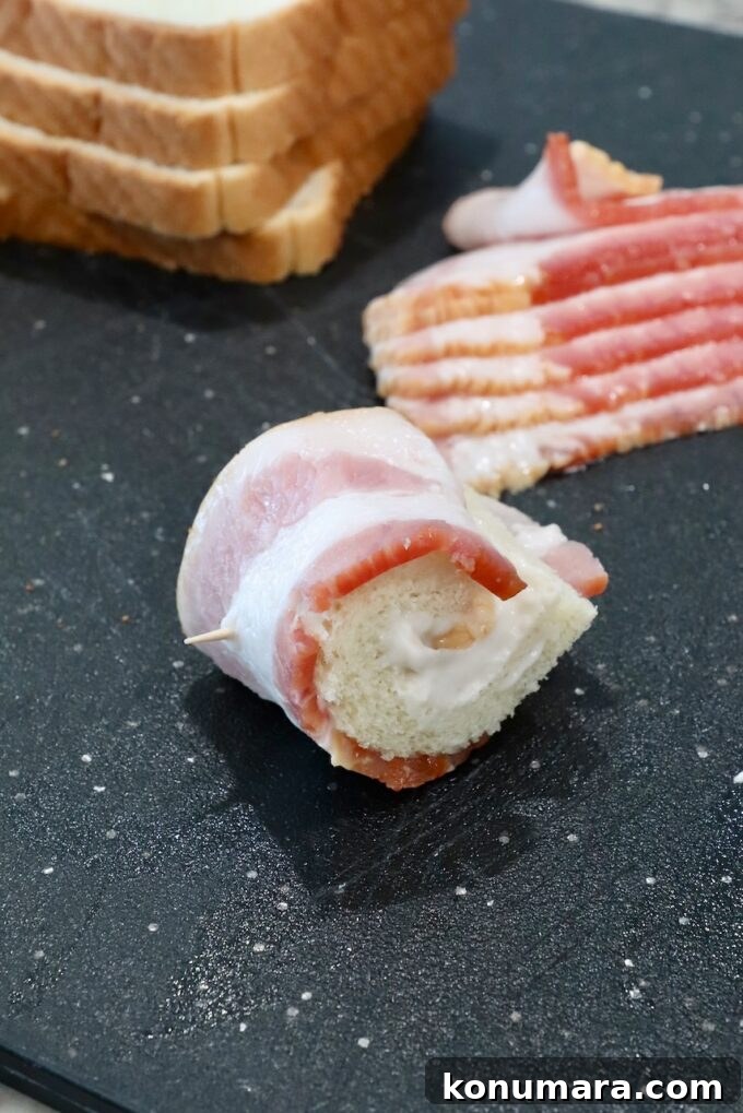 Crispy Bacon Roll Ups with Cream Cheese and Chives 6 slice of bread rolled up in a slice of bacon, secured with a toothpick