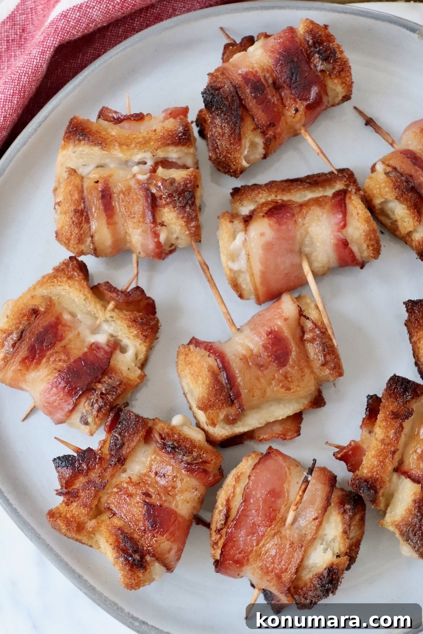 Crispy Bacon Roll Ups with Cream Cheese and Chives 8 bacon roll ups on a plate