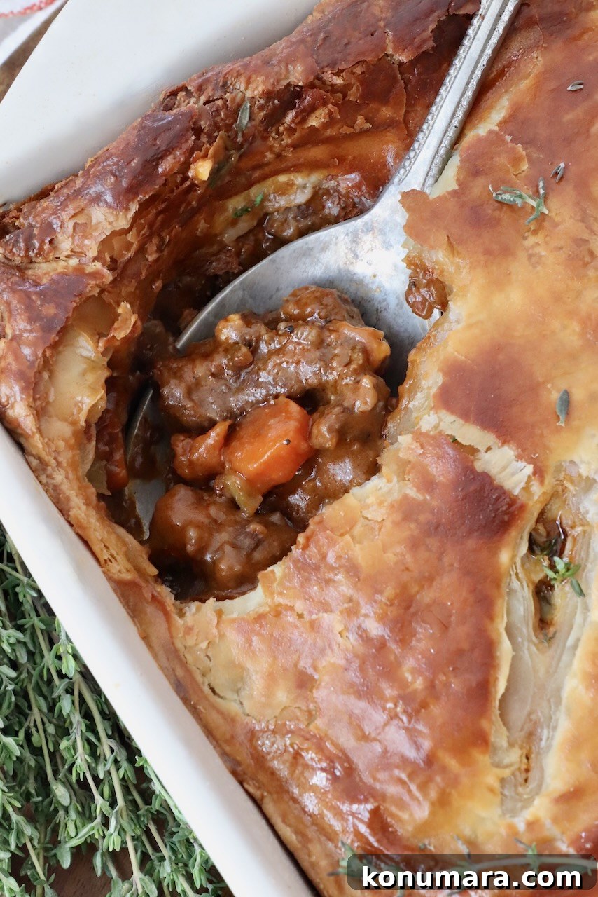 serving spoon in a baked beef pot pie