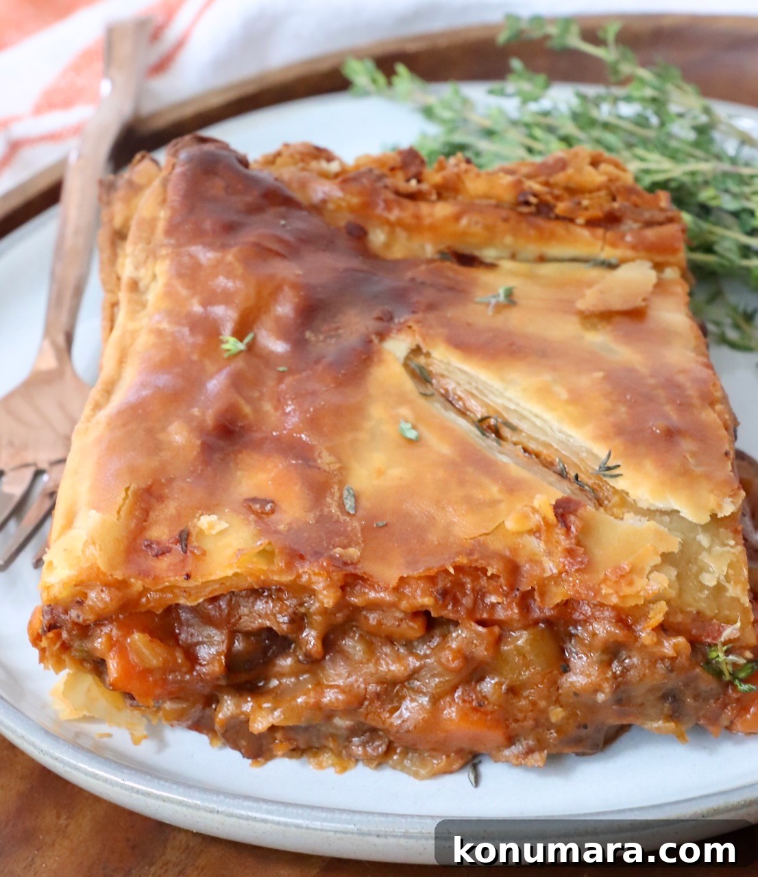piece of beef pot pie on a plate with a fork