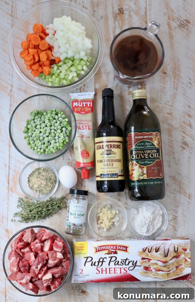 ingredients for beef pot pie on a white wood board