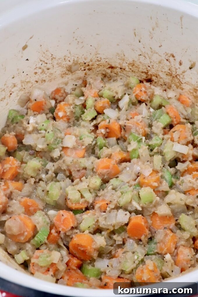 flour mixed with diced vegetables in a dutch oven