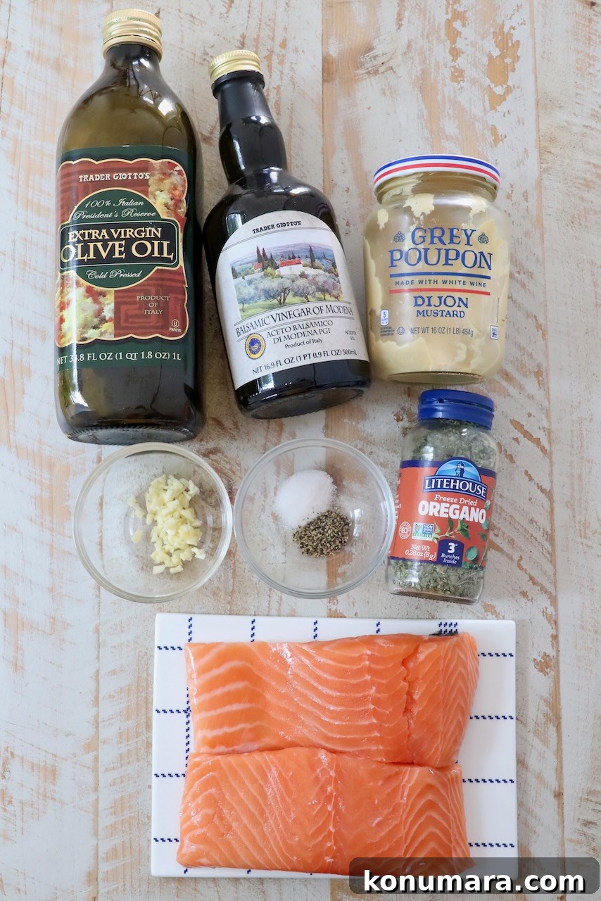ingredients for balsamic glazed salmon on a white wood board