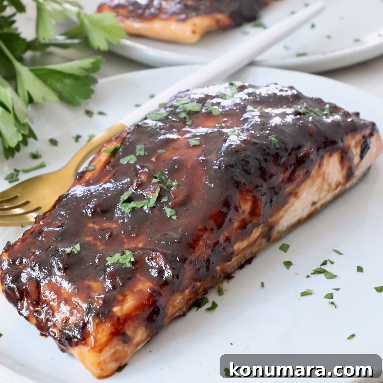 balsamic glazed salmon on a plate with a fork