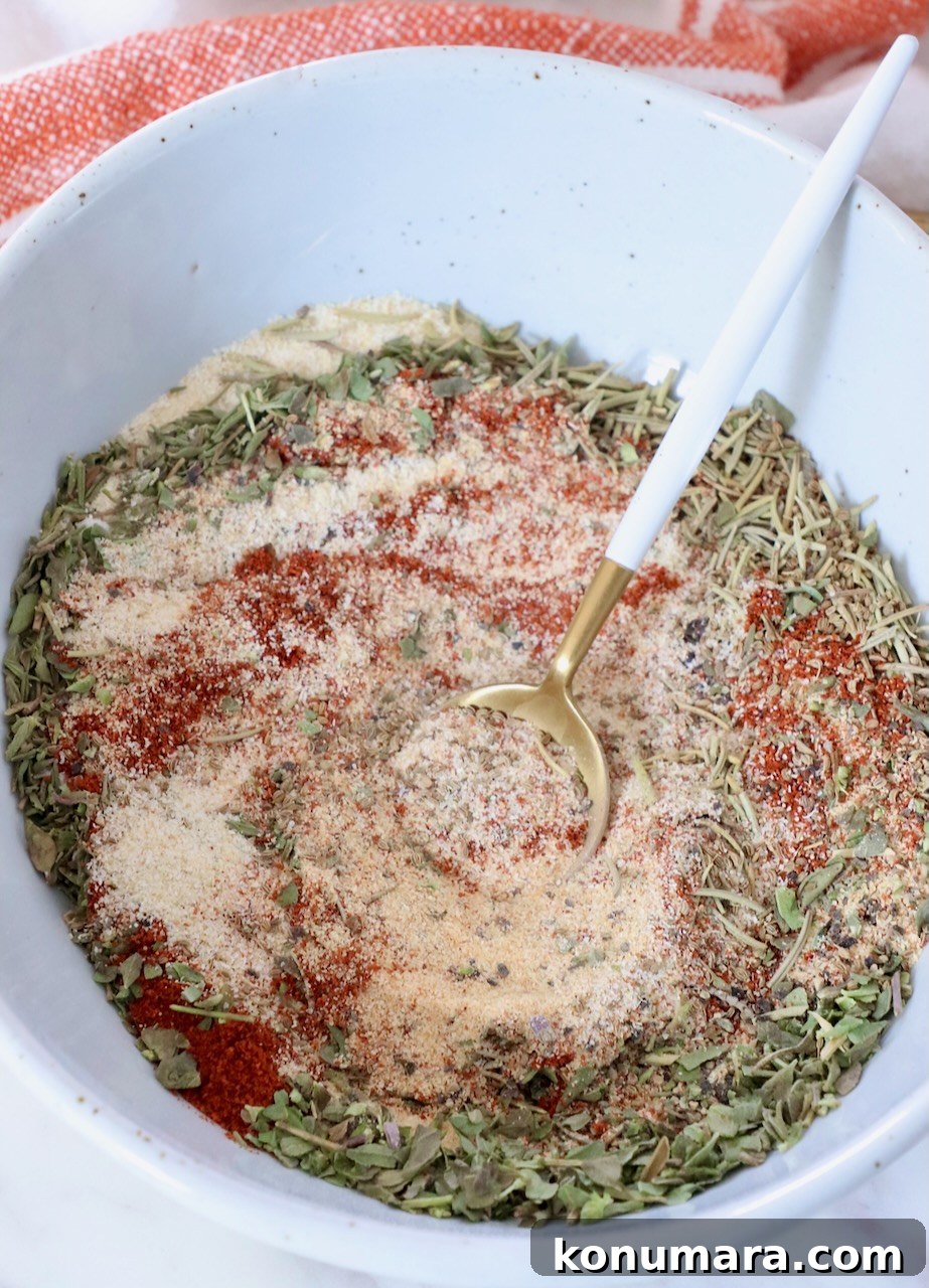 Homemade Beef Stew Seasoning for Rich Savory Flavor 2 dried herbs and spices combined in a bowl with a spoon