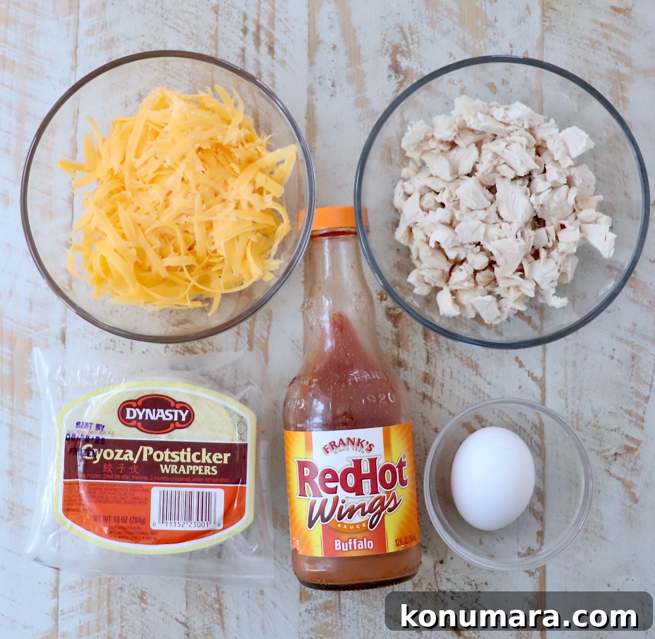 Crispy Buffalo Chicken Bites Recipe with Blue Cheese Dip 3 ingredients for buffalo chicken bites on a white wood board