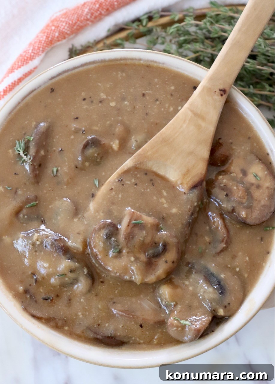 mushroom gravy in a bowl with a spoon