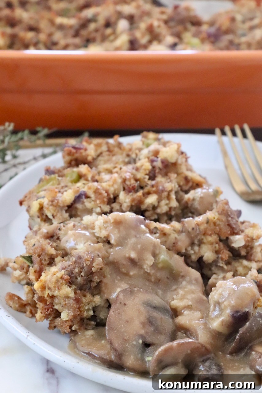 sausage stuffing on a plate topped with mushroom gravy