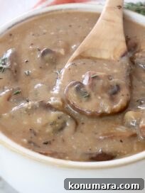 mushroom gravy in a bowl with a spoon