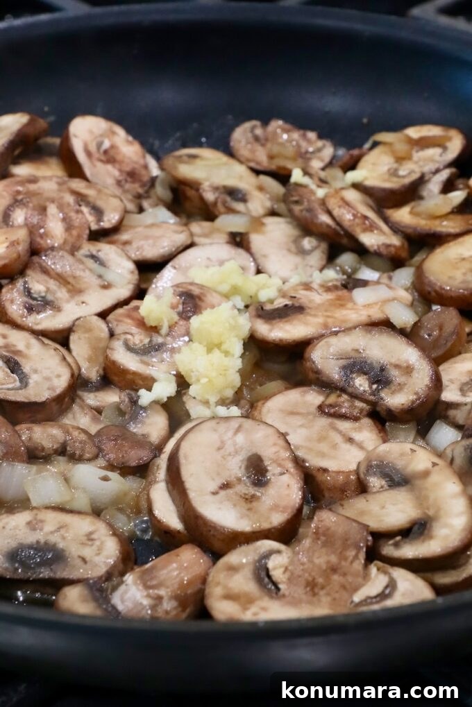 sliced mushrooms and minced garlic in a large skillet