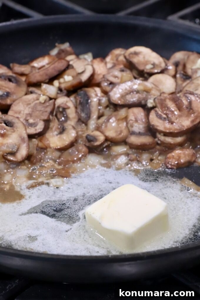 melted butter in a large skillet with sliced mushrooms