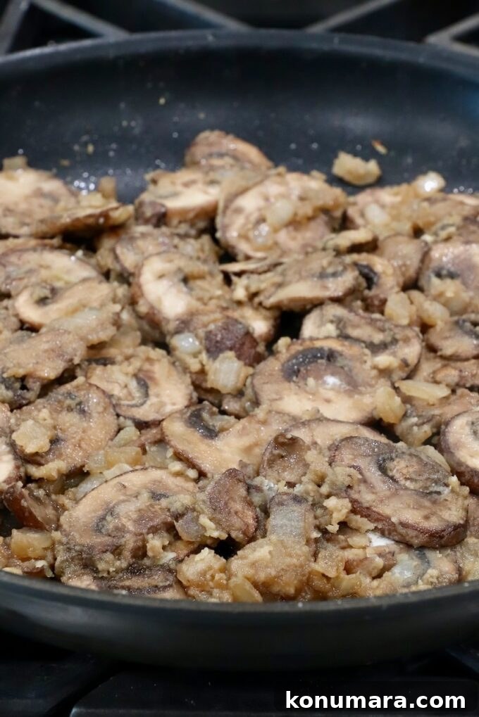 sliced mushrooms combined with a roux in a large skillet