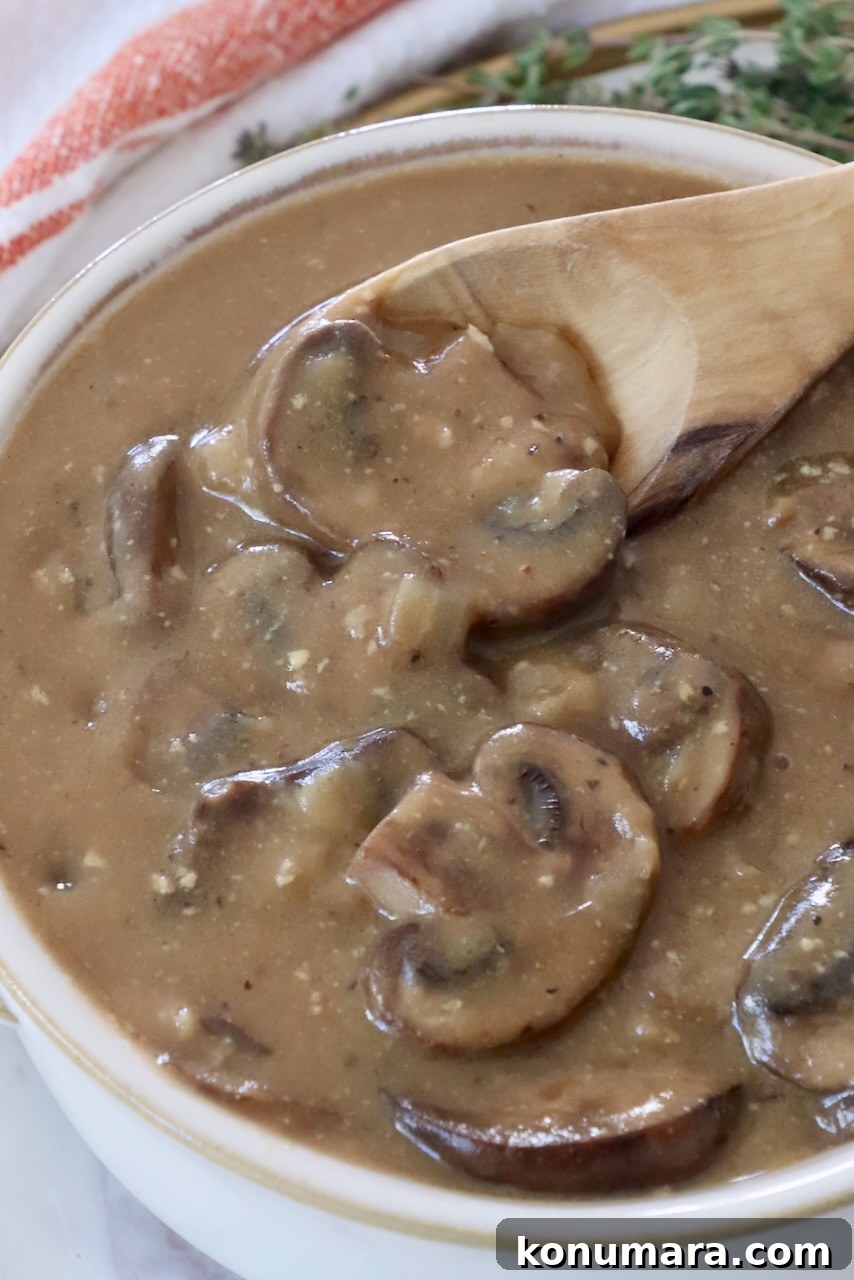 mushroom gravy in a bowl with a spoon