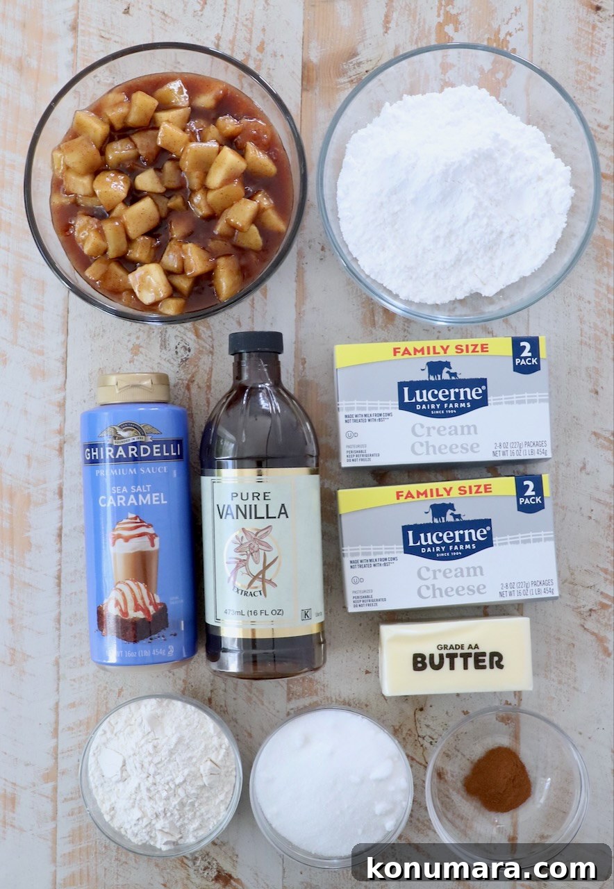 Ingredients for apple pie dip on a white wood board
