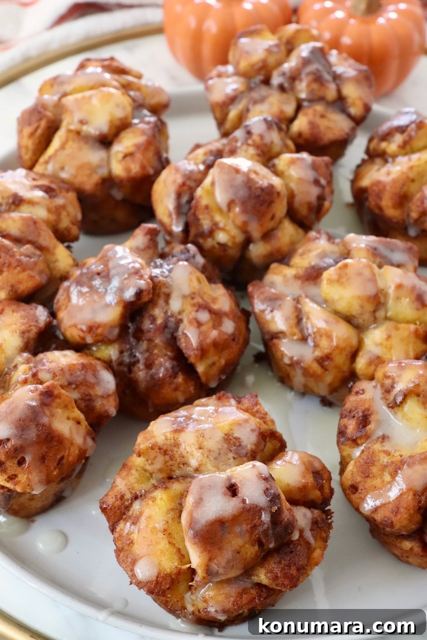 Maple-Glazed Pull-Apart Pumpkin Cinnamon Rolls 11 pull apart pumpkin cinnamon rolls on a plate