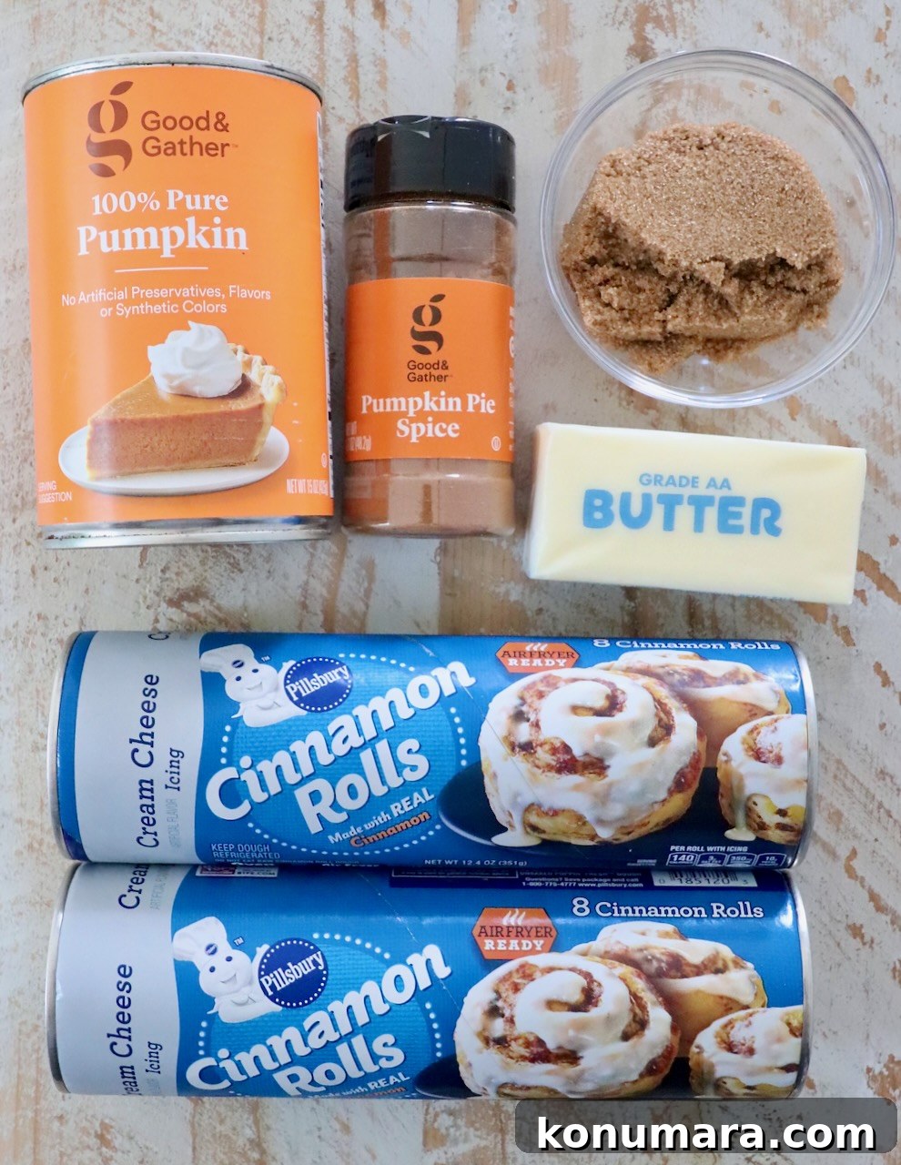 Maple-Glazed Pull-Apart Pumpkin Cinnamon Rolls 3 ingredients for pumpkin cinnamon rolls on a white wood board