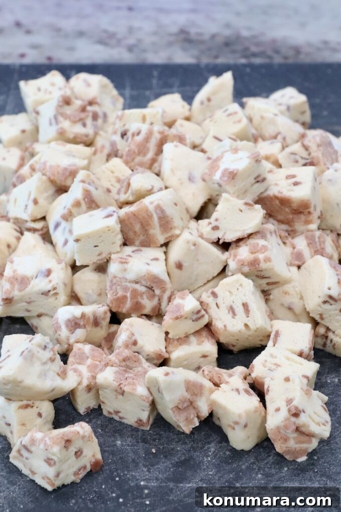 Maple-Glazed Pull-Apart Pumpkin Cinnamon Rolls 5 canned cinnamon rolls cut into small cubes on a cutting board