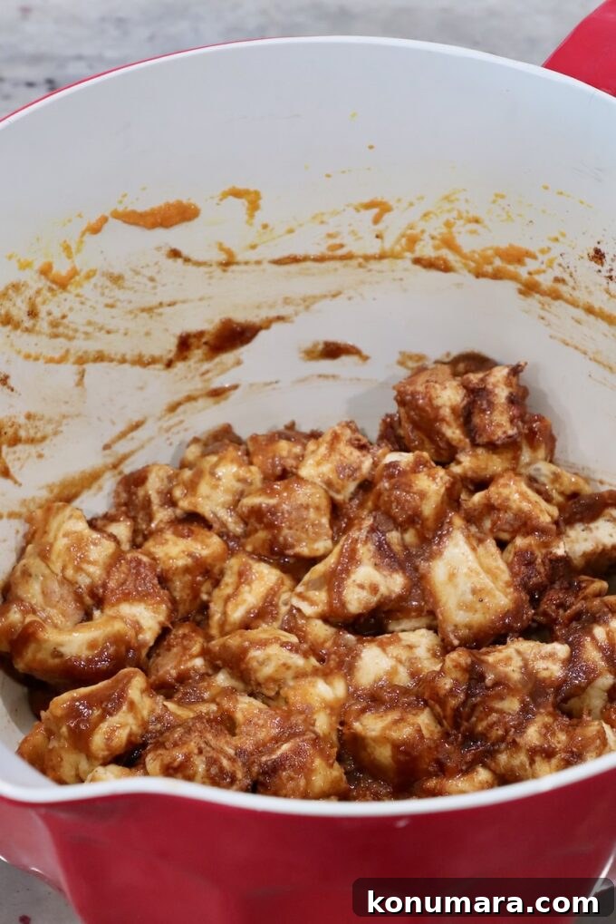 Maple-Glazed Pull-Apart Pumpkin Cinnamon Rolls 7 diced up cinnamon rolls tossed with pumpkin puree, brown sugar and cinnamon in a mixing bowl