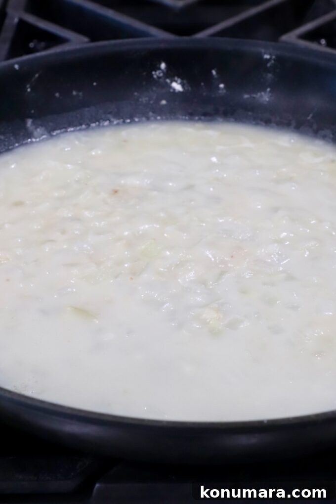 Creamy Au Gratin Potatoes Recipe 6 diced onions and garlic in a skillet with flour and broth