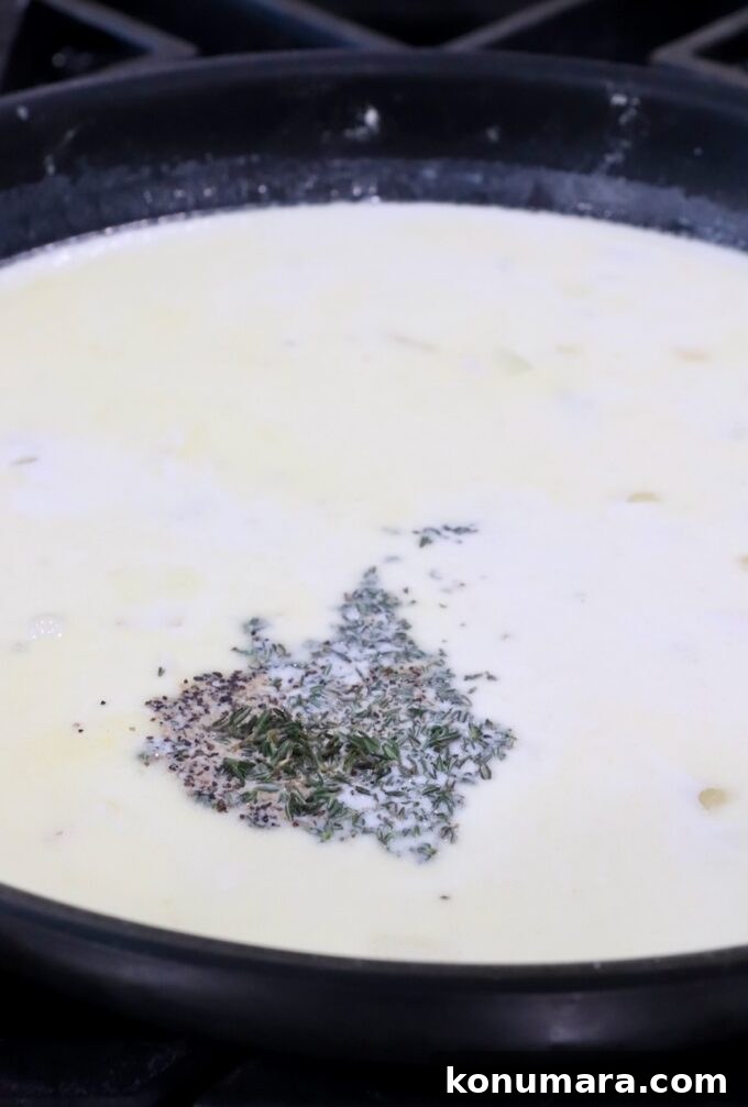 Creamy Au Gratin Potatoes Recipe 7 creamy sauce in a skillet with dried herbs and spices