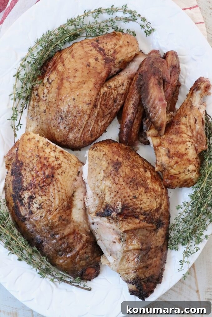 Smoked Turkey Recipe for Thanksgiving: Juicy, Crispy Skin 9 turkey thighs, drumsticks and wings on a platter with fresh herbs
