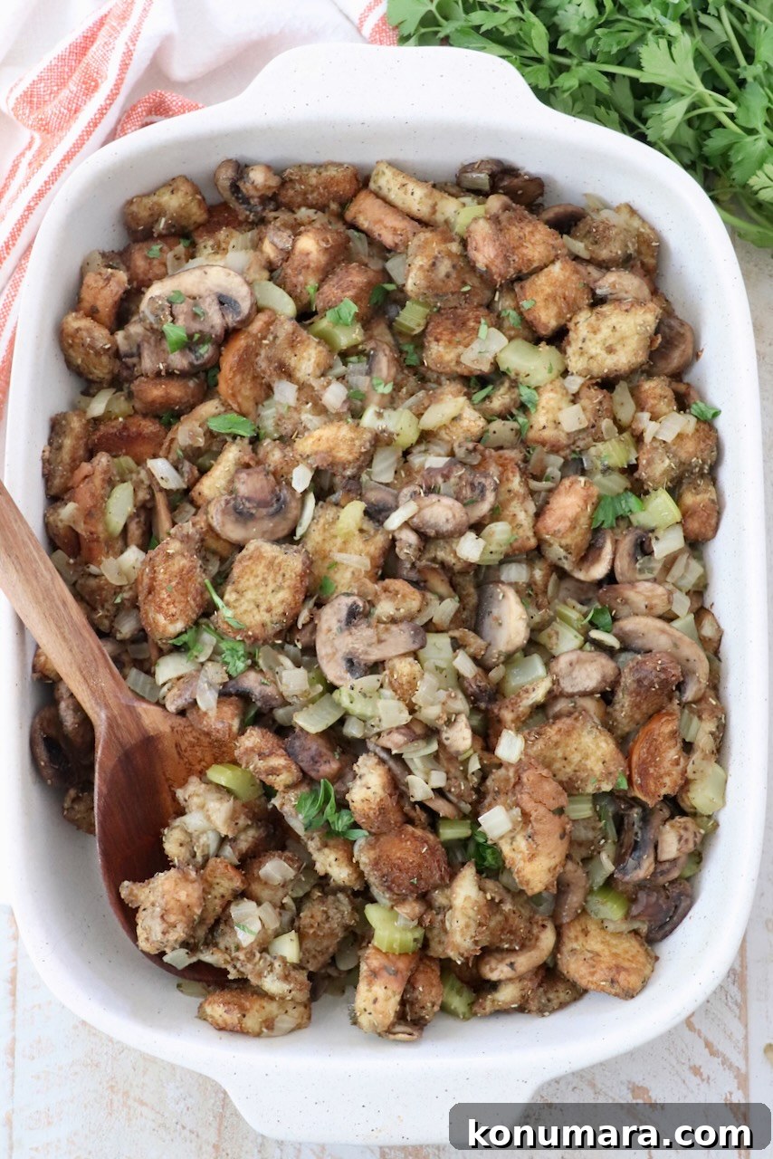 Mushroom Stuffing Recipe with Garlic and Herbs 2 mushroom stuffing in a casserole dish with a serving spoon
