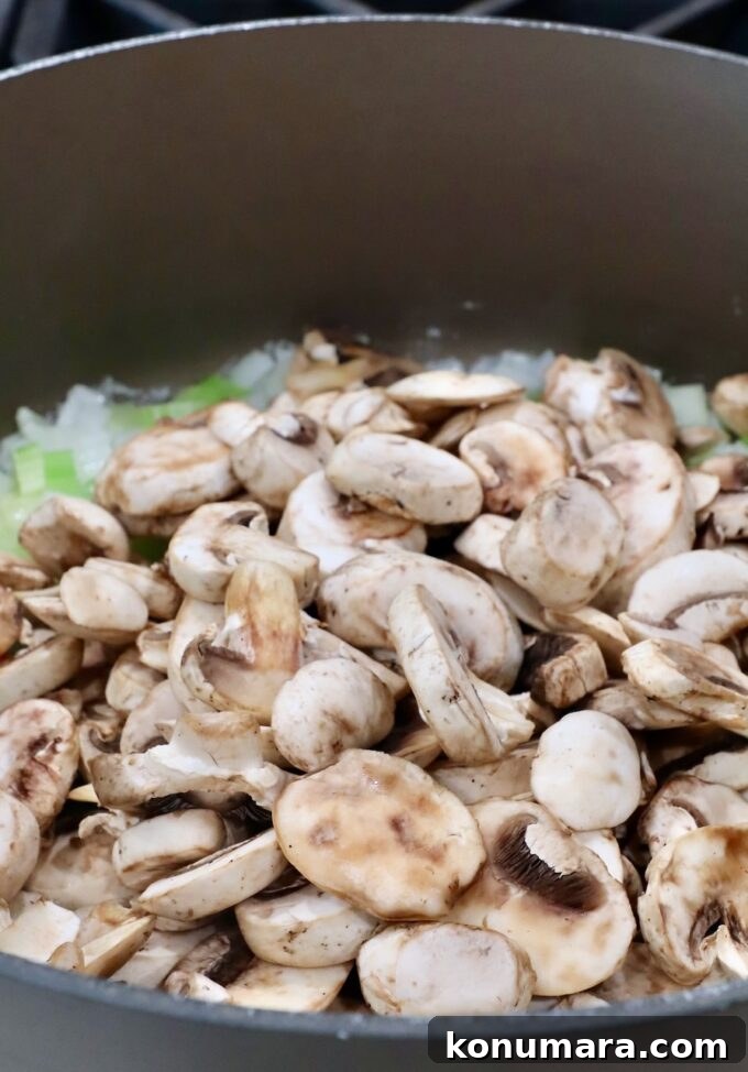 Mushroom Stuffing Recipe with Garlic and Herbs 6 diced onions and celery with sliced mushrooms in a large pot
