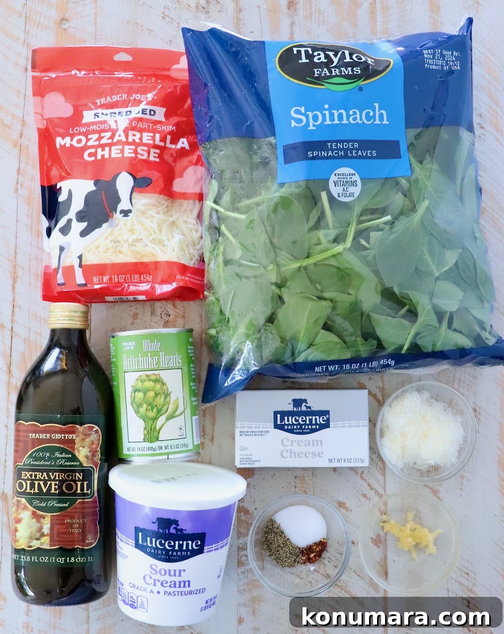 Creamy Baked Spinach and Artichoke Dip Recipe 3 ingredients for spinach artichoke dip on a white wood board