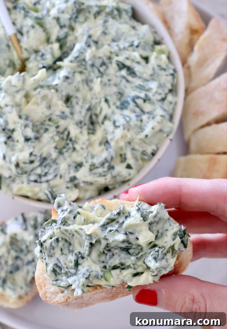 Creamy Baked Spinach and Artichoke Dip Recipe 8 spinach artichoke dip in a bowl and spread on a slice of baguette