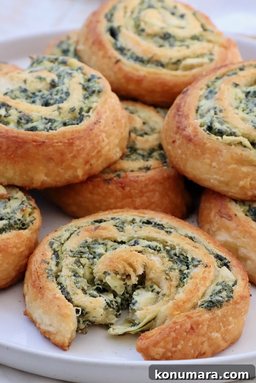 Spinach Pinwheels: Savory Appetizer Recipe 2 spinach dip rolls stacked up on a plate