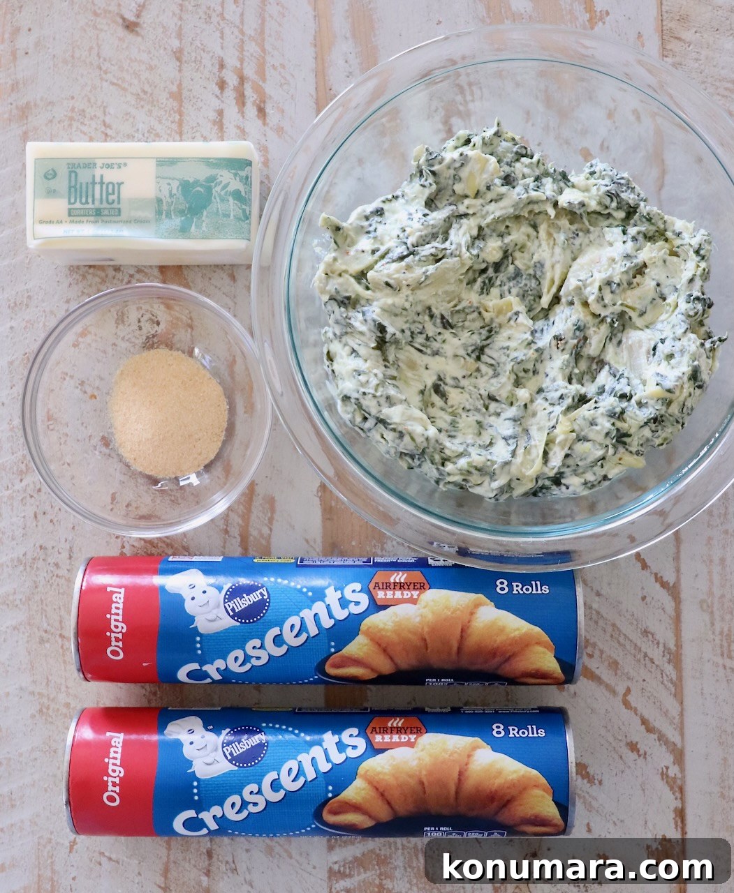 Spinach Pinwheels: Savory Appetizer Recipe 3 ingredients for spinach pinwheels on a white wood board