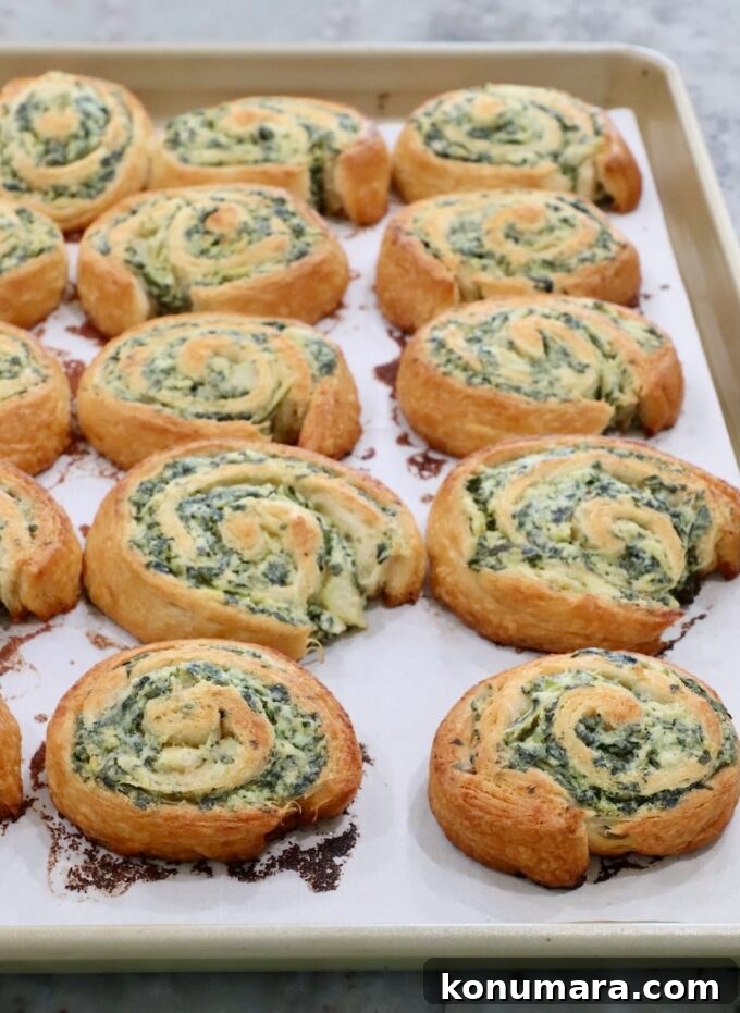 Spinach Pinwheels: Savory Appetizer Recipe 7 baked spinach pinwheels on a baking sheet