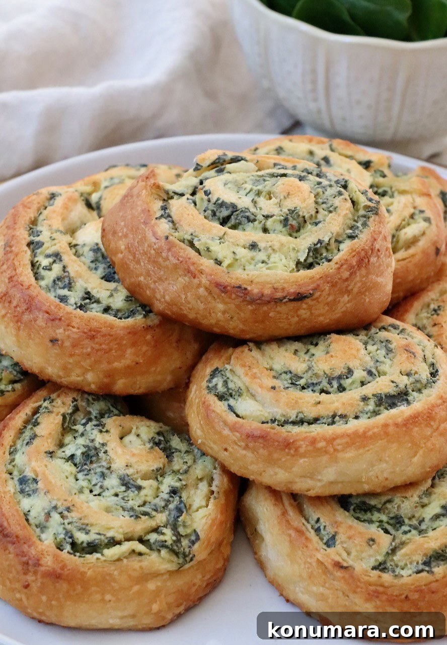 Spinach Pinwheels: Savory Appetizer Recipe 9 spinach rolls stacked up on a plate