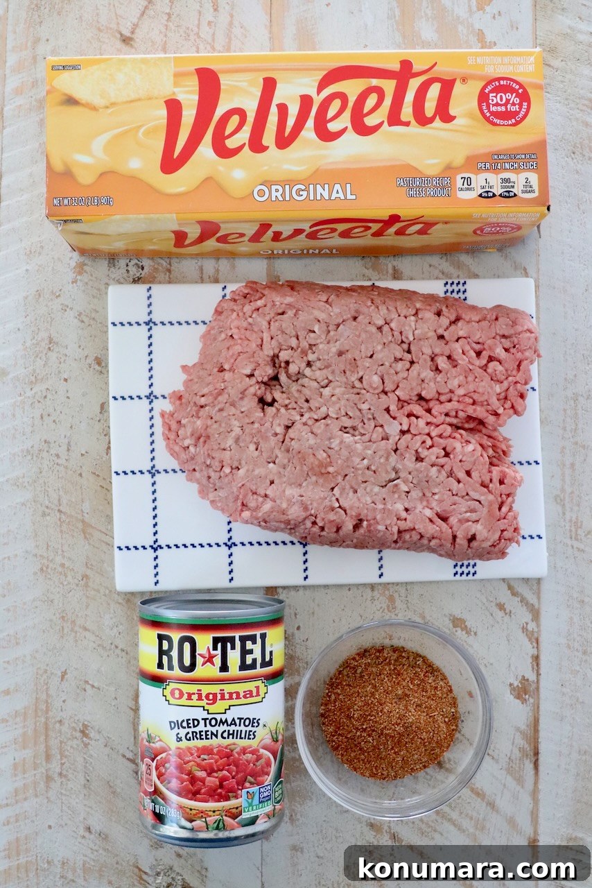 ingredients in rotel dip on a white wood board