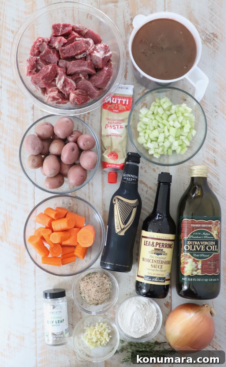 ingredients for Irish stew on a white wood board