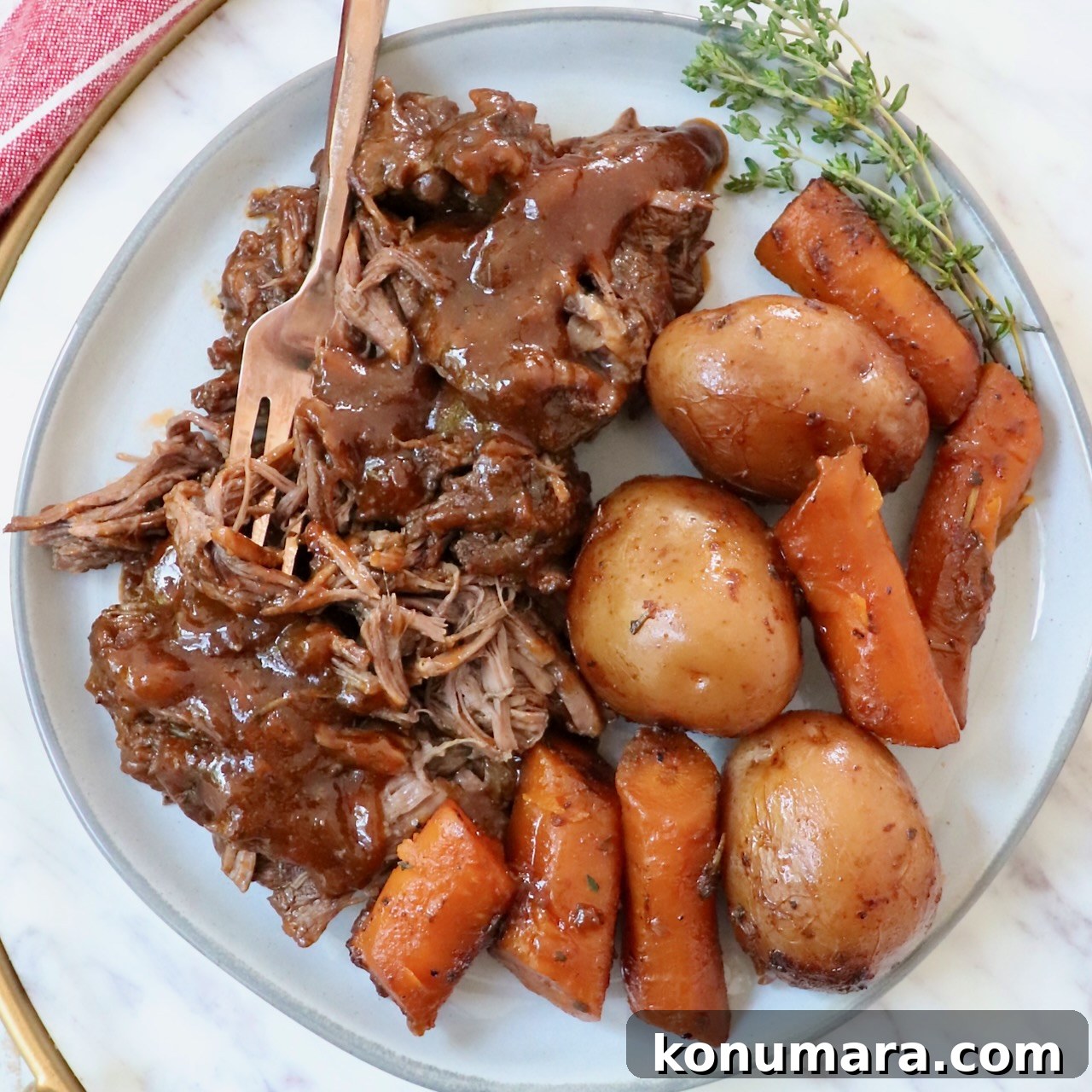 pot roast with gravy, potatoes, and carrots