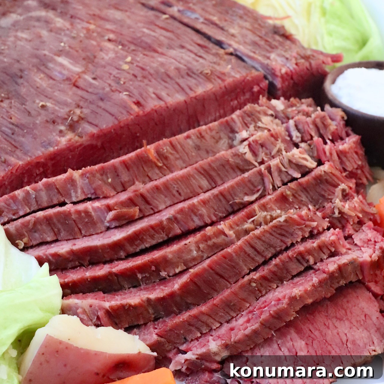 sliced corned beef served with cabbage, potatoes, and carrots